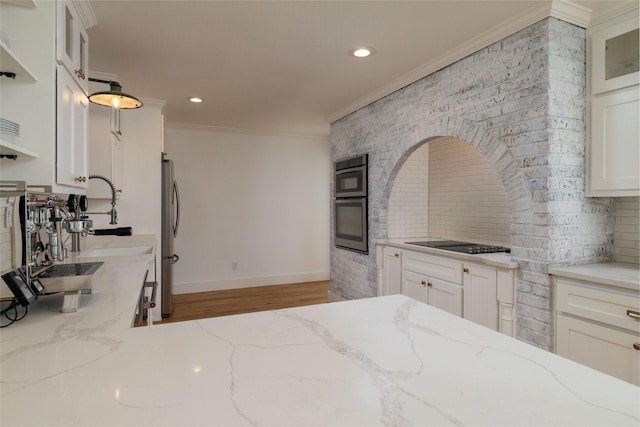 kitchen with white cabinets, light stone counters, and tasteful backsplash