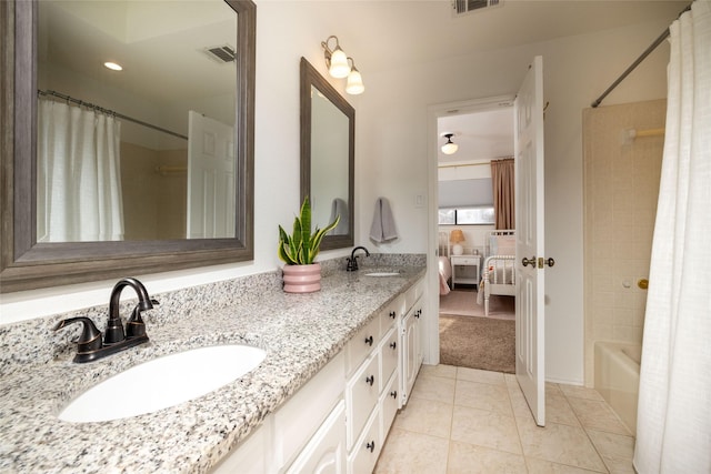 bathroom featuring tile patterned flooring, vanity, and shower / bath combination with curtain