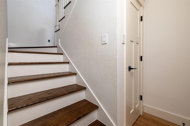 staircase featuring hardwood / wood-style flooring