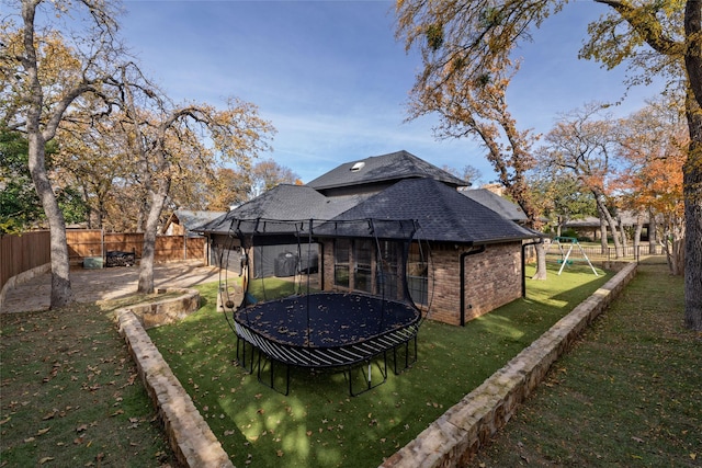 view of yard featuring a playground and a trampoline