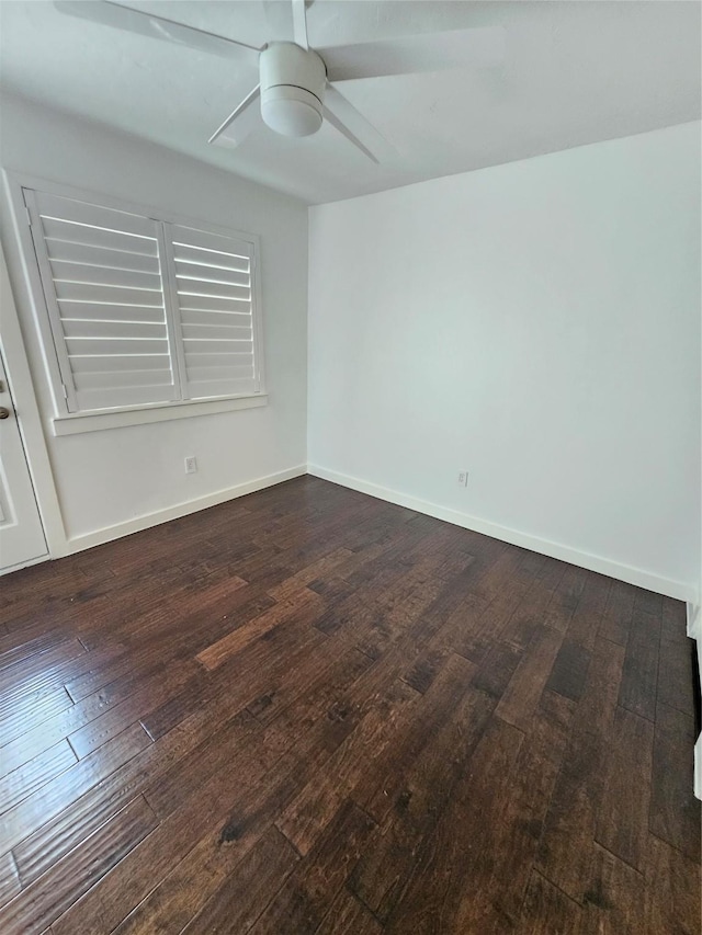 empty room with ceiling fan and dark hardwood / wood-style floors