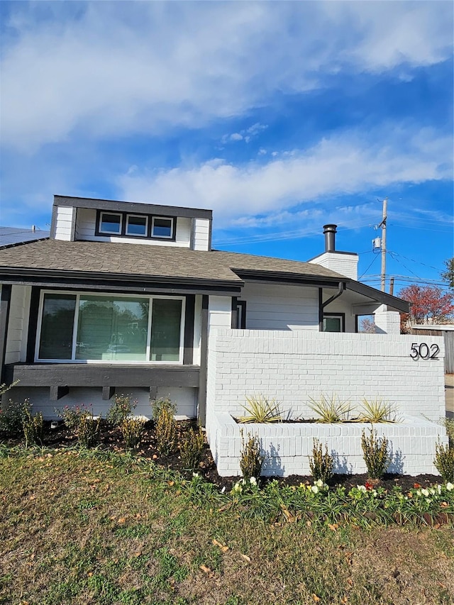 view of side of property with a yard