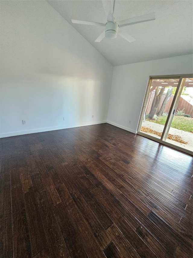 spare room featuring vaulted ceiling, dark wood-type flooring, and ceiling fan