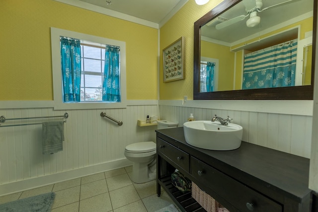 bathroom with crown molding, vanity, toilet, and tile patterned flooring