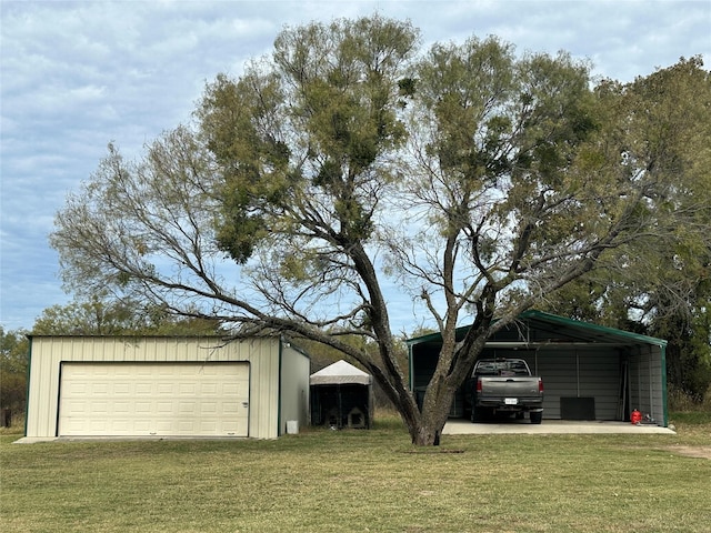 garage featuring a yard and a carport