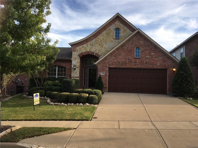 view of front of house with a front yard and a garage