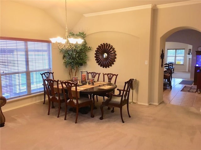 dining space with carpet flooring, a chandelier, a wealth of natural light, and vaulted ceiling