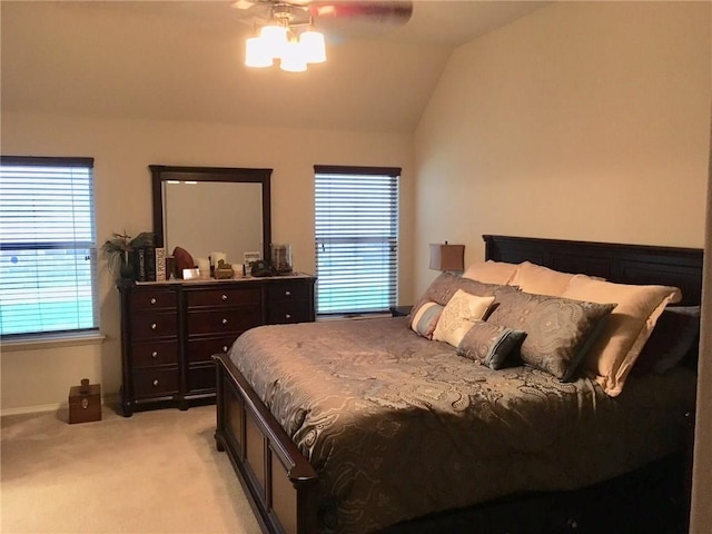 carpeted bedroom with ceiling fan and lofted ceiling