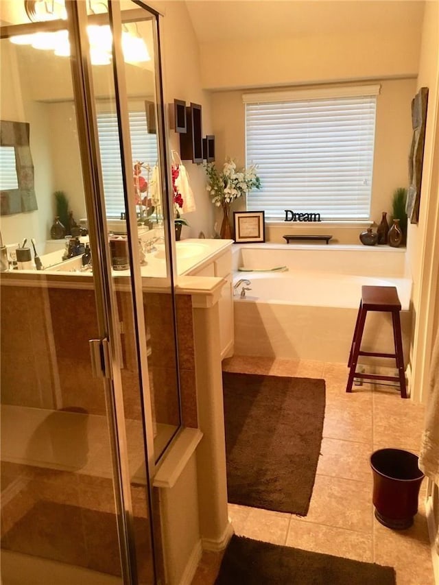 bathroom with separate shower and tub and tile patterned floors