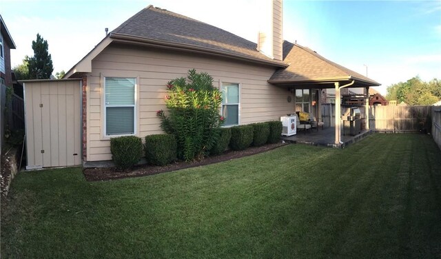 rear view of house featuring a yard and a patio