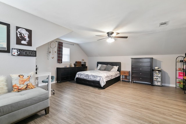 bedroom featuring hardwood / wood-style flooring, ceiling fan, and vaulted ceiling