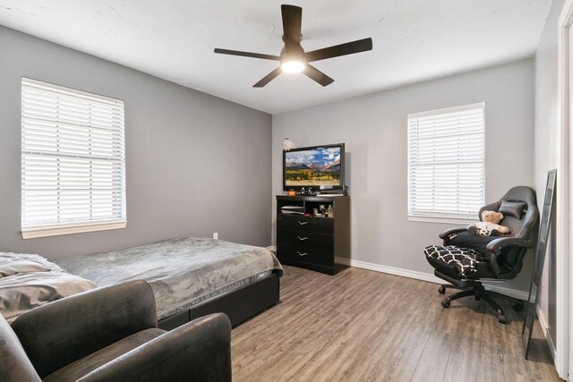 bedroom with ceiling fan and light hardwood / wood-style flooring