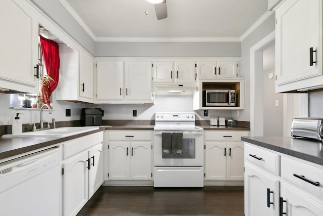 kitchen featuring white appliances, crown molding, dark wood-type flooring, sink, and white cabinets