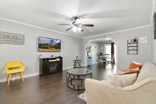 living room with ceiling fan, dark hardwood / wood-style floors, and ornamental molding