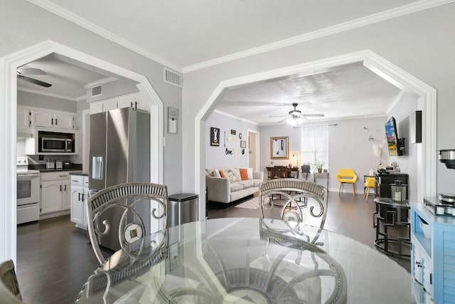 dining area with crown molding and dark wood-type flooring