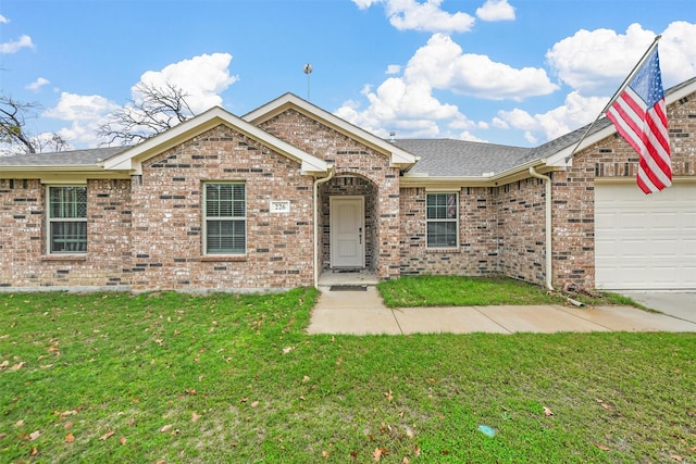 view of front of property featuring a front yard and a garage