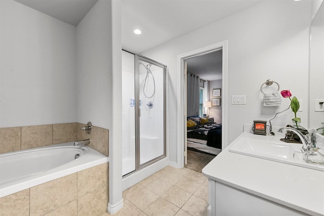 bathroom featuring tile patterned floors, vanity, and shower with separate bathtub