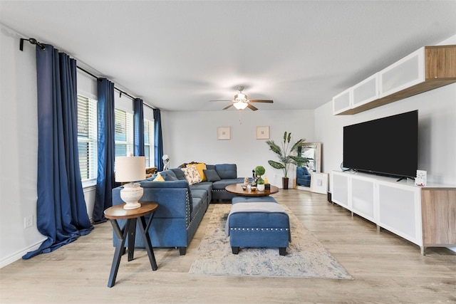 living room featuring ceiling fan and light hardwood / wood-style floors