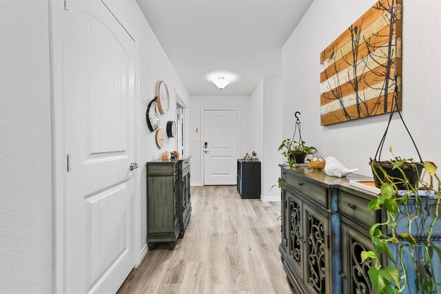 hallway with light hardwood / wood-style flooring