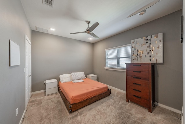 bedroom with light colored carpet, visible vents, and baseboards