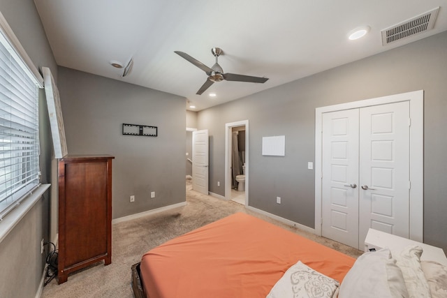 bedroom featuring a closet, visible vents, a ceiling fan, light carpet, and baseboards