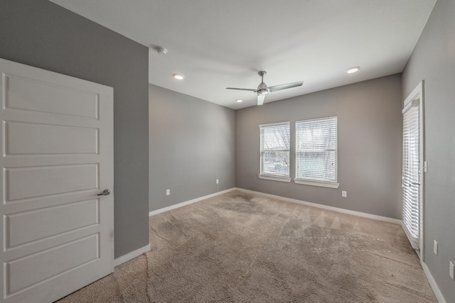 carpeted spare room featuring baseboards, a ceiling fan, and recessed lighting