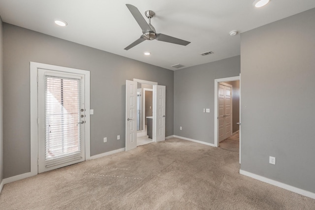 unfurnished bedroom featuring access to outside, multiple windows, and carpet