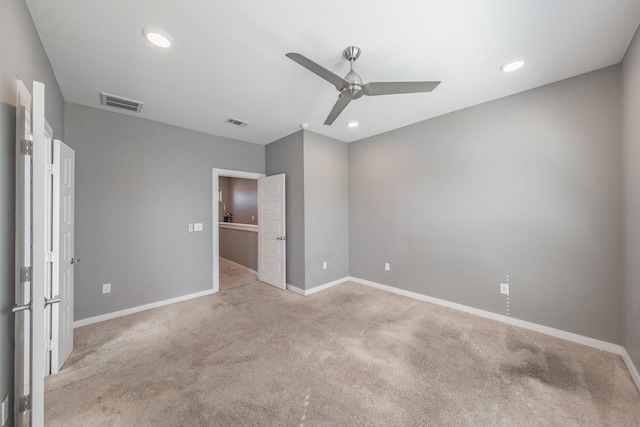 unfurnished bedroom with baseboards, visible vents, and light colored carpet