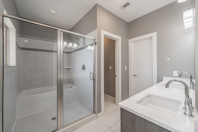 full bath featuring double vanity, visible vents, tile patterned floors, a shower stall, and a sink