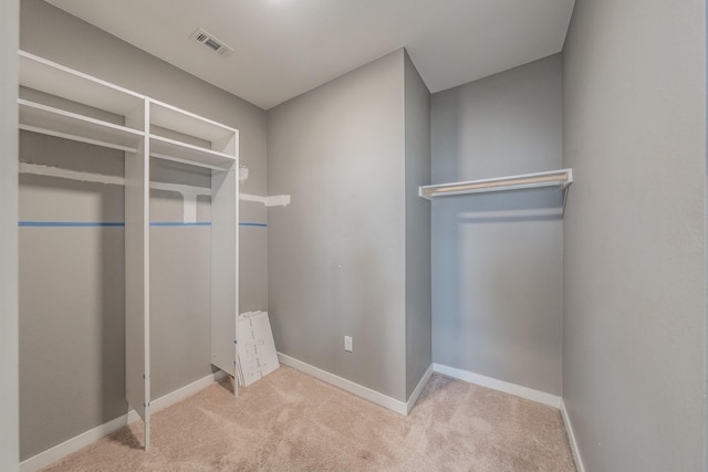 spacious closet with visible vents and carpet flooring