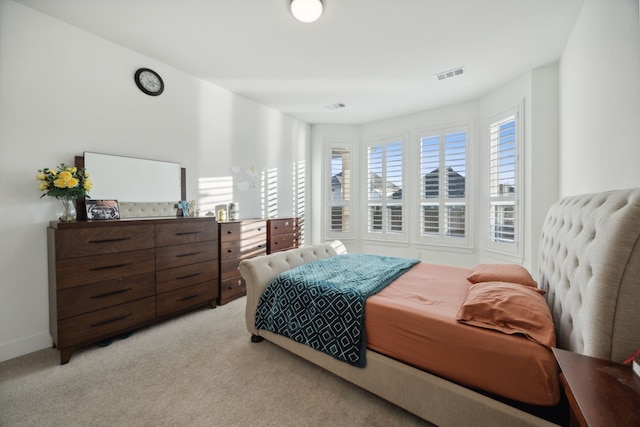 bedroom featuring light colored carpet