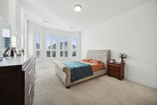 bedroom featuring light colored carpet