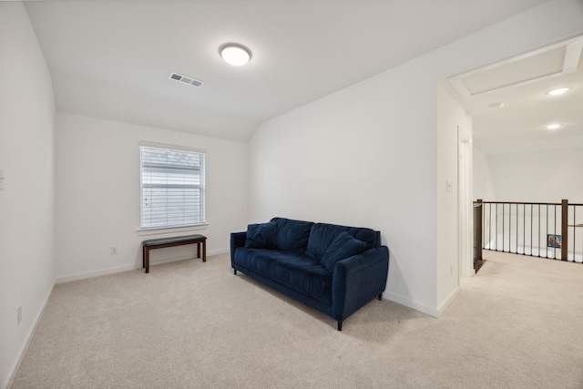 sitting room with light colored carpet and lofted ceiling