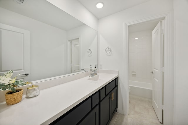 bathroom with tile patterned flooring, bathing tub / shower combination, and vanity