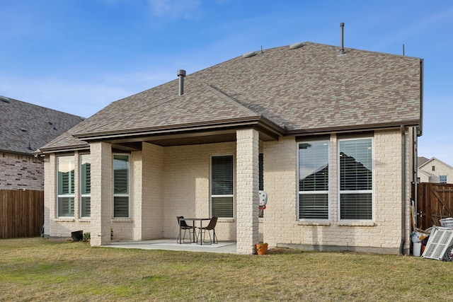 rear view of property with a yard and a patio area