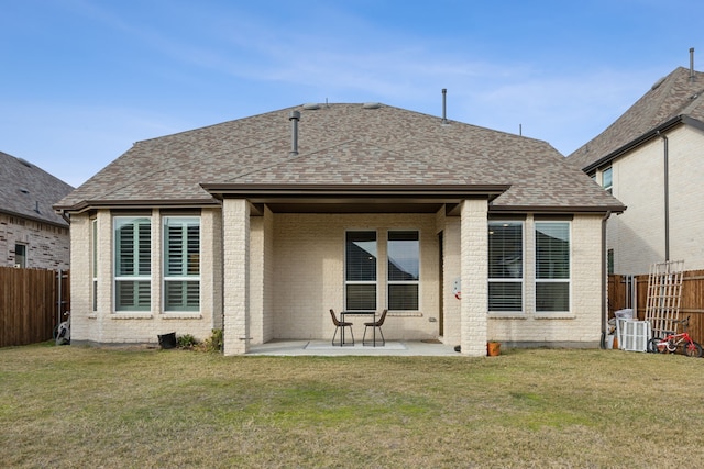 back of property with a yard and a patio area