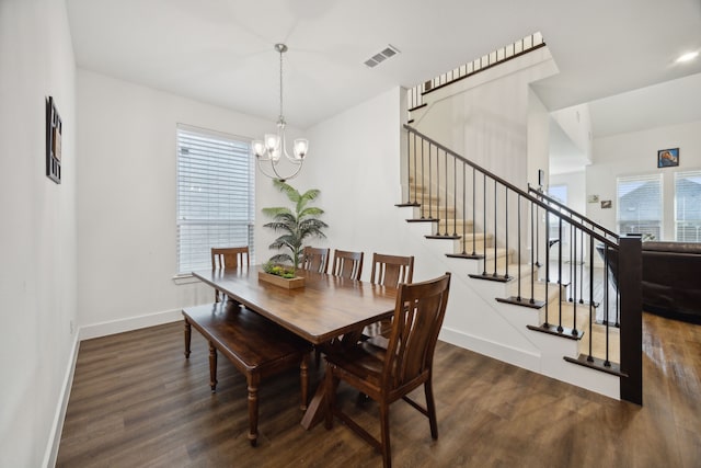 dining room with a notable chandelier and dark hardwood / wood-style floors