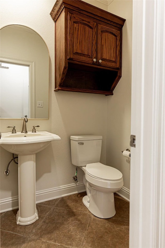 bathroom featuring tile patterned flooring, toilet, and sink