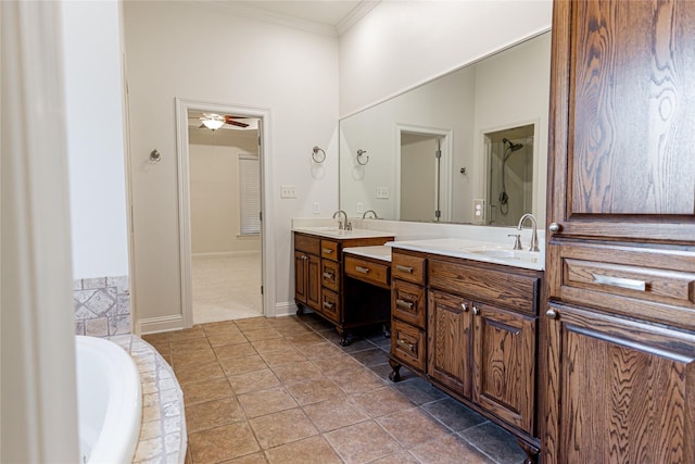 bathroom with ornamental molding, vanity, ceiling fan, tiled tub, and tile patterned flooring