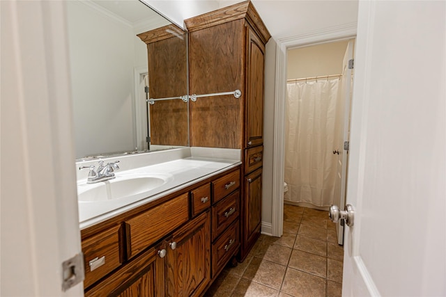 bathroom featuring tile patterned flooring, ornamental molding, vanity, and toilet