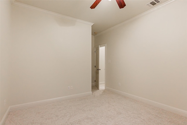 carpeted spare room featuring ceiling fan and ornamental molding