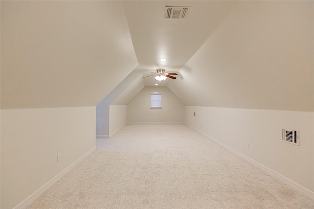 additional living space featuring ceiling fan, light carpet, and vaulted ceiling