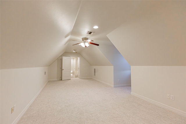 additional living space with light colored carpet, ceiling fan, and lofted ceiling