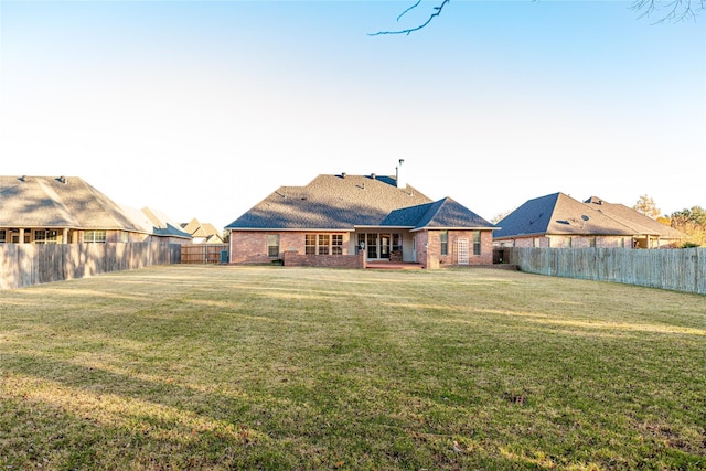 rear view of house with a yard