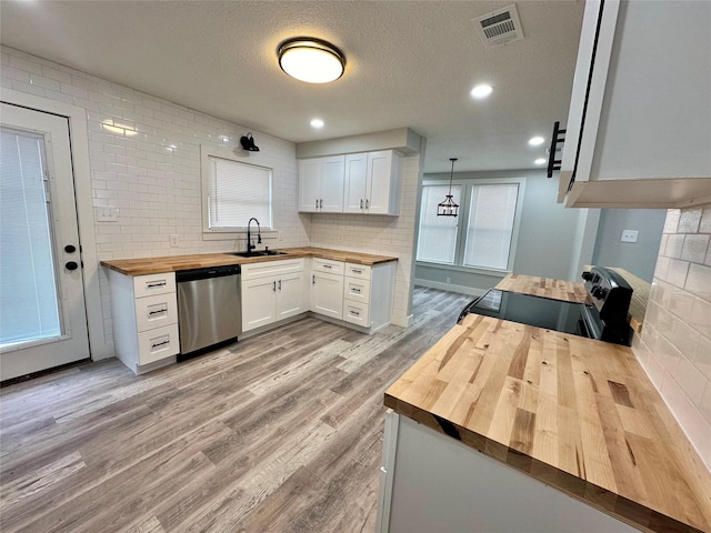 kitchen with pendant lighting, dishwasher, butcher block counters, white cabinetry, and range with electric stovetop