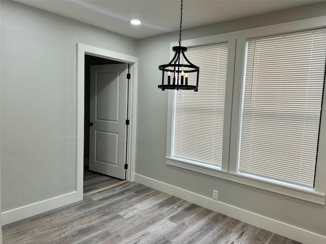 unfurnished dining area featuring light wood-style flooring, baseboards, and recessed lighting