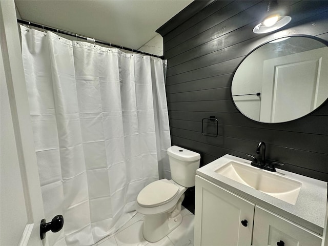 bathroom with vanity, toilet, a shower with shower curtain, and wood walls