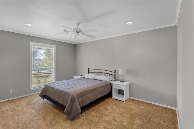 carpeted bedroom featuring ceiling fan and crown molding