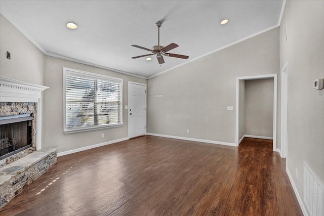 unfurnished living room featuring ornamental molding, a stone fireplace, and dark hardwood / wood-style flooring