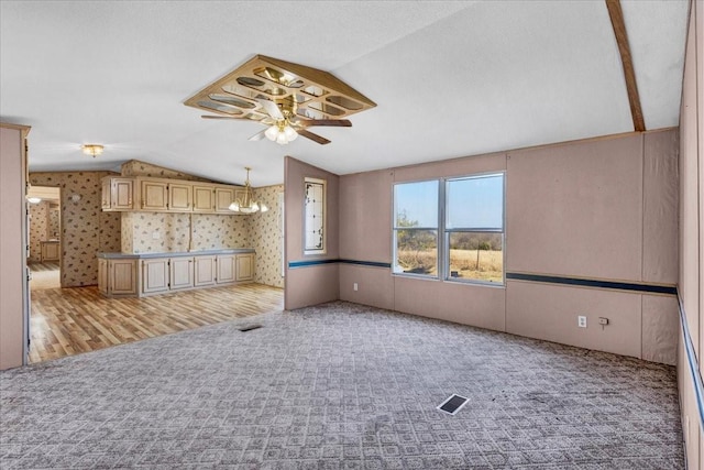 3529 Bennett Ln, Sherman, TX 75092 - unfurnished living room featuring light colored carpet, visible vents, ceiling fan, and vaulted ceiling
